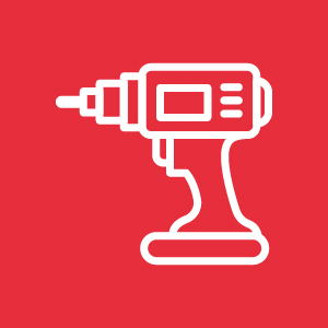 Taladro eléctrico sobre fondo rojo